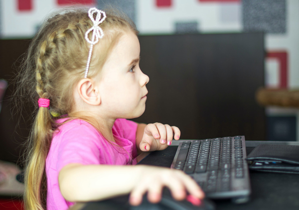 little girl using computer